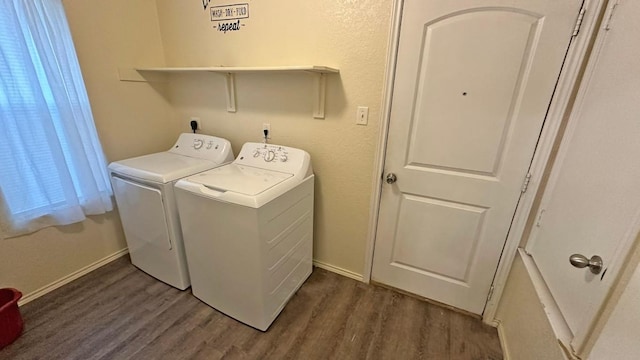 laundry room featuring dark hardwood / wood-style flooring and washer and clothes dryer