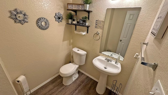 bathroom featuring hardwood / wood-style floors and toilet