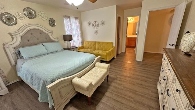 bedroom with ensuite bath, ceiling fan, and dark wood-type flooring