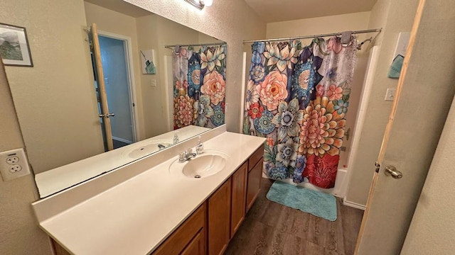 bathroom with vanity, shower / bath combination with curtain, and hardwood / wood-style flooring