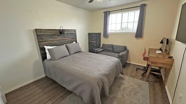 bedroom with dark hardwood / wood-style flooring and ceiling fan