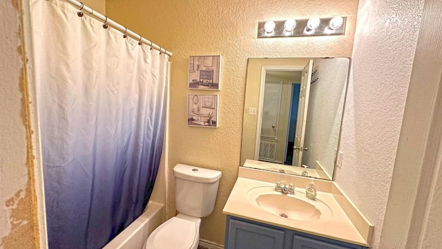 full bathroom with vanity, shower / tub combo, and toilet