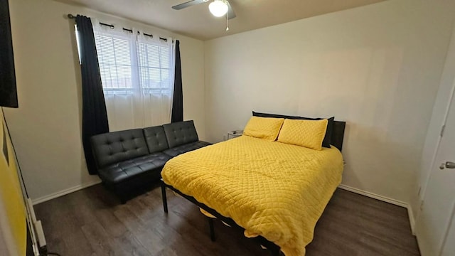 bedroom with ceiling fan and dark wood-type flooring