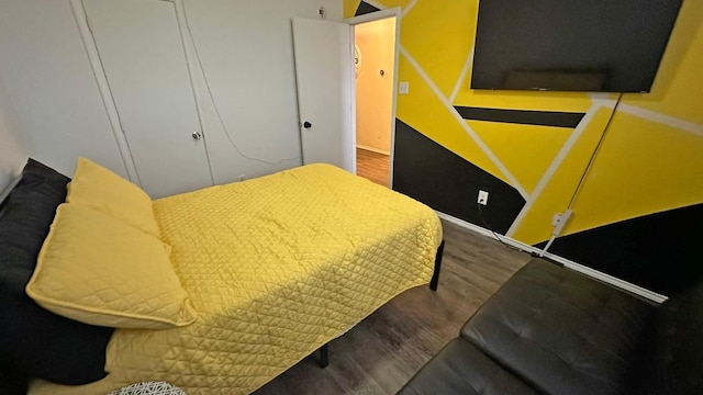 bedroom with a closet and wood-type flooring