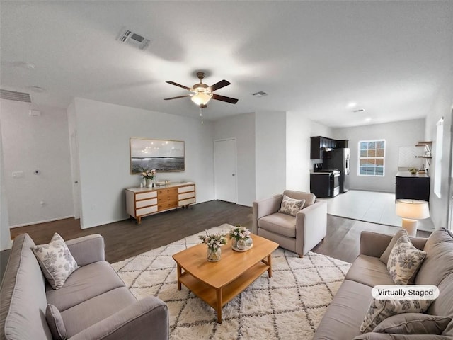 living room with ceiling fan and light wood-type flooring