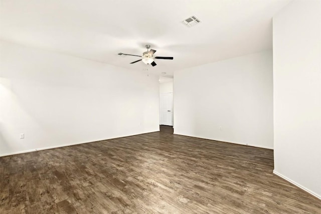 spare room with ceiling fan and dark hardwood / wood-style flooring