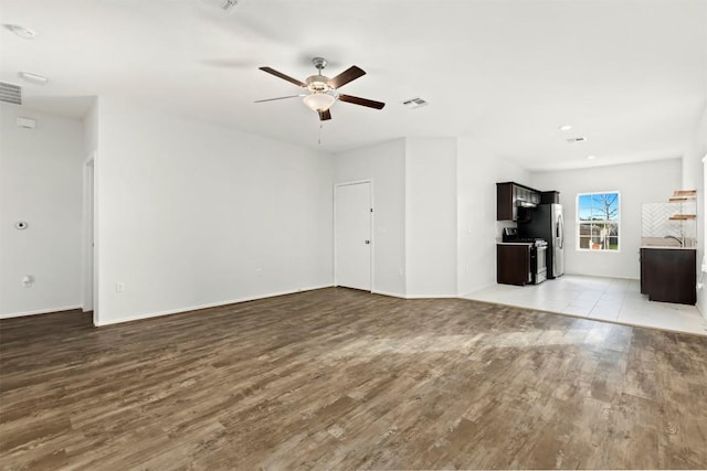 unfurnished living room featuring ceiling fan and light hardwood / wood-style floors