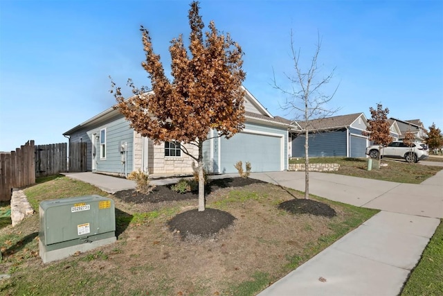 view of front of home with a front yard and a garage