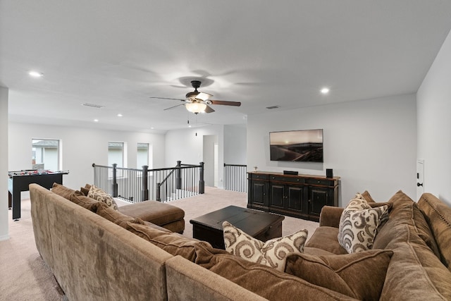 living room featuring ceiling fan and light colored carpet