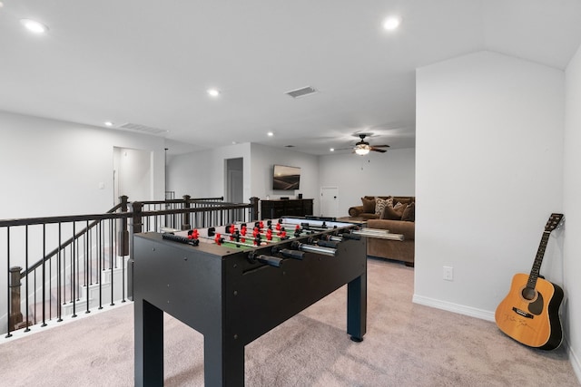 recreation room with ceiling fan and light carpet