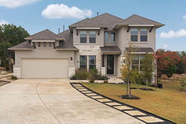 view of front of property featuring a garage and a front lawn