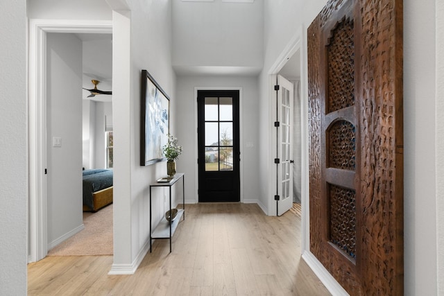 foyer entrance featuring ceiling fan and light hardwood / wood-style flooring