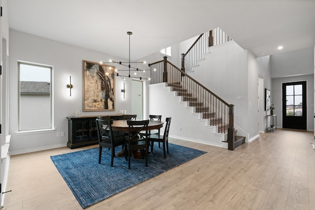 dining space featuring a chandelier and light wood-type flooring