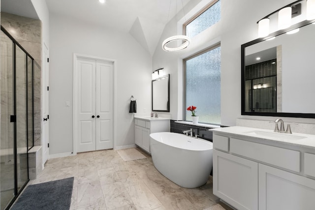 bathroom with vanity, shower with separate bathtub, and vaulted ceiling