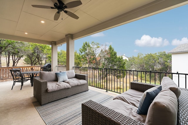 wooden terrace featuring an outdoor living space and ceiling fan