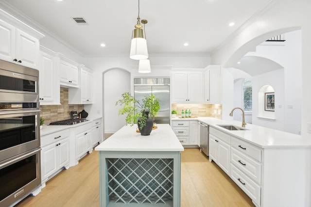 kitchen with visible vents, appliances with stainless steel finishes, light wood-style floors, white cabinets, and a sink