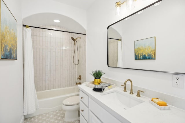 full bathroom featuring toilet, shower / bathtub combination with curtain, and vanity