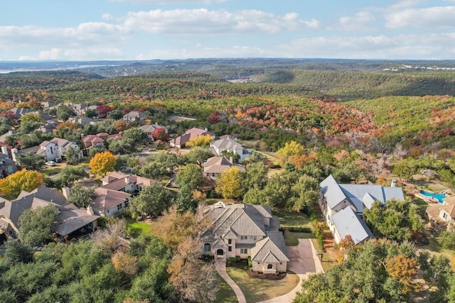 birds eye view of property with a residential view and a wooded view