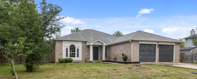 view of front of house with a garage and a front lawn