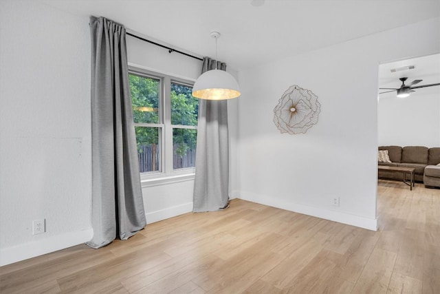 unfurnished dining area with hardwood / wood-style flooring and ceiling fan