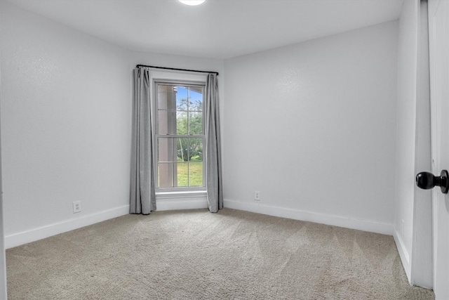 spare room with light colored carpet