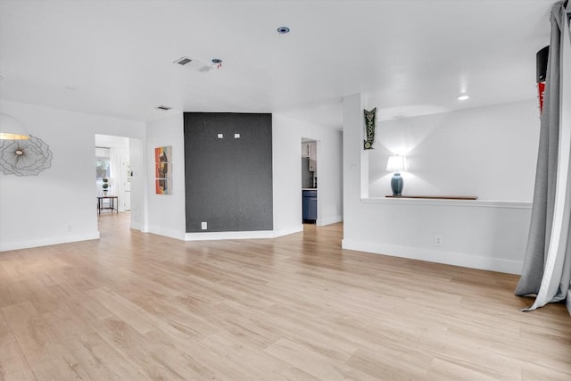 unfurnished living room with light wood-type flooring