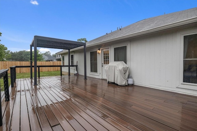 wooden deck featuring a grill