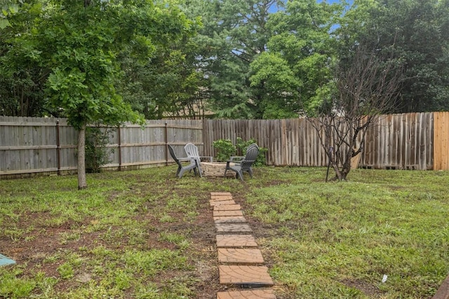 view of yard with a fire pit