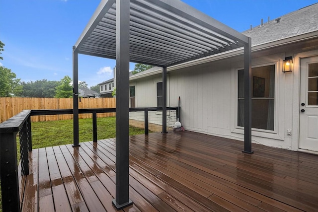 wooden deck featuring a lawn