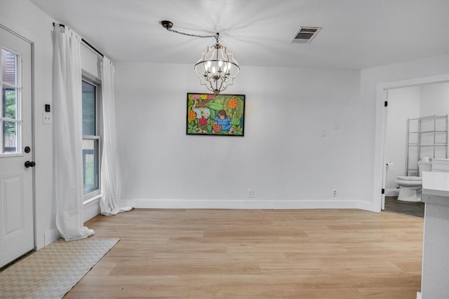 dining area featuring a chandelier and light hardwood / wood-style flooring