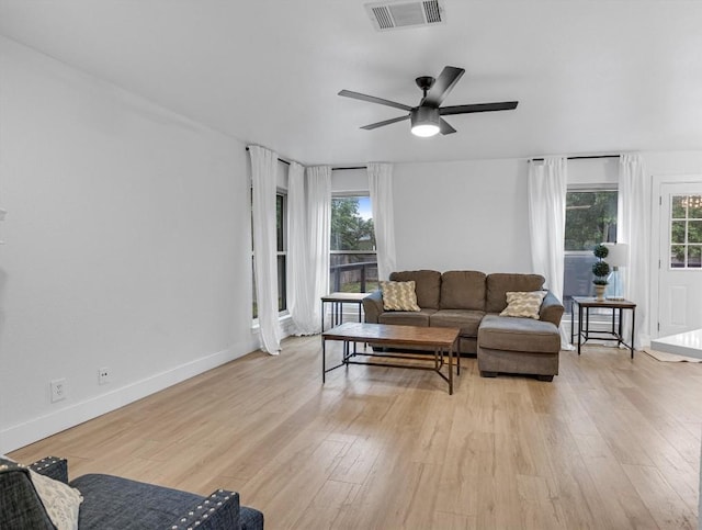 living room featuring ceiling fan and light hardwood / wood-style floors