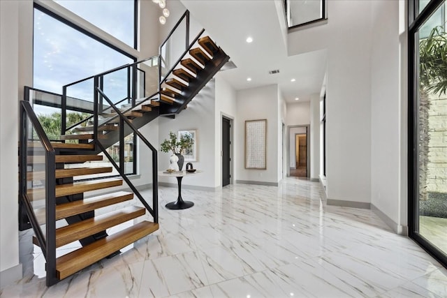 entrance foyer featuring a high ceiling and a healthy amount of sunlight