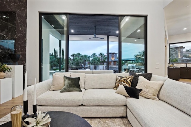 living room featuring a wealth of natural light, ceiling fan, and wood-type flooring