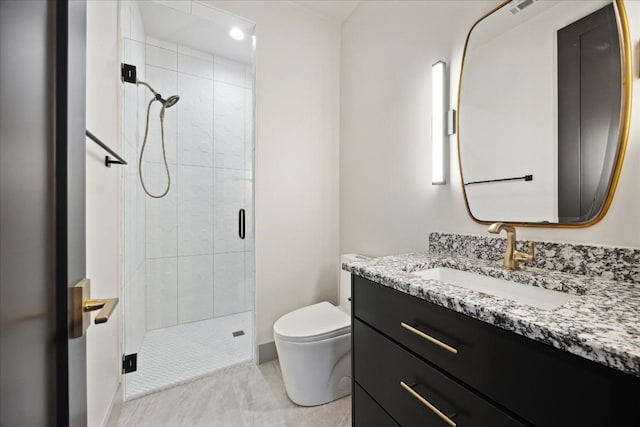 bathroom with vanity, toilet, and a shower with shower door