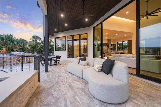 patio terrace at dusk with an outdoor hangout area, area for grilling, and ceiling fan