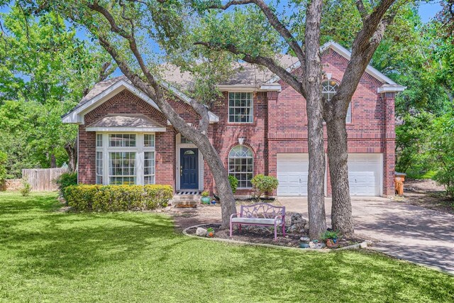 view of front of property with brick siding, a front lawn, and fence