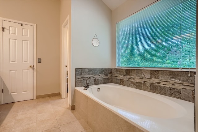 bathroom featuring tile patterned floors and tiled tub