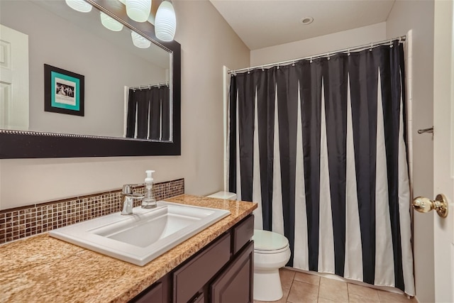 bathroom with tile patterned flooring, curtained shower, toilet, and vanity