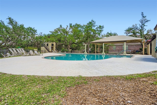 view of swimming pool featuring a patio, a fenced in pool, fence, and a pergola