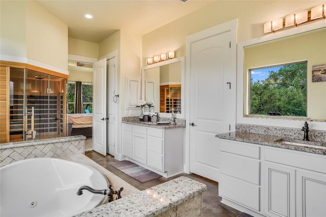 bathroom with vanity and a bath