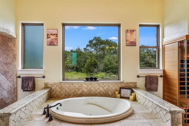 bathroom featuring a relaxing tiled tub