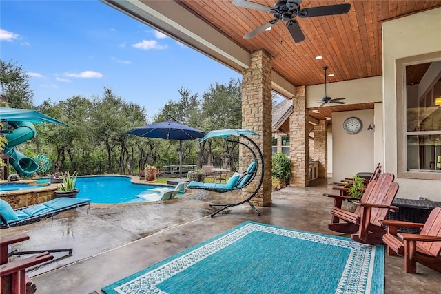 view of pool with ceiling fan, a patio, and a jacuzzi