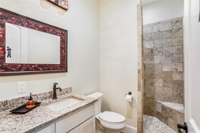 bathroom featuring vanity, toilet, and walk in shower