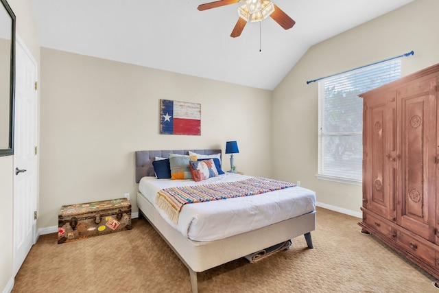 bedroom featuring multiple windows, ceiling fan, light carpet, and vaulted ceiling