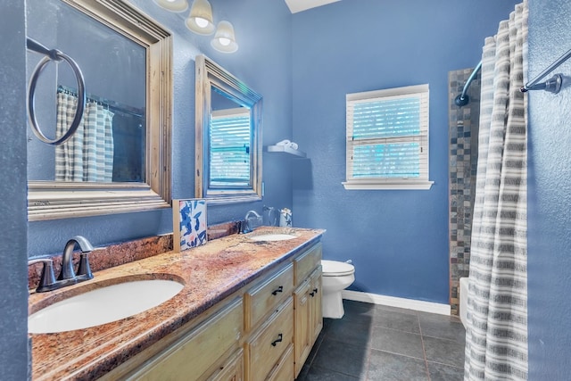 bathroom featuring tile patterned floors, curtained shower, vanity, and toilet