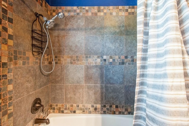 bathroom with shower / bath combo with shower curtain