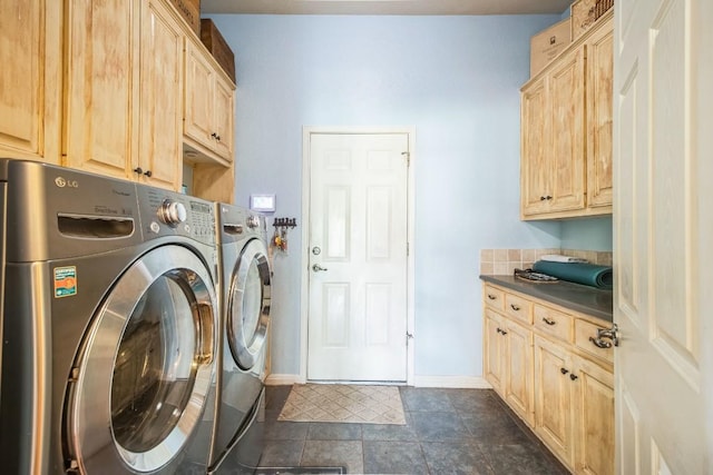 laundry room with washer and clothes dryer and cabinets