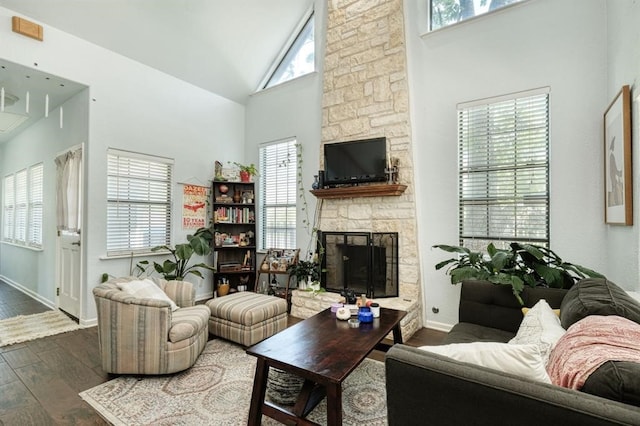 living room with dark hardwood / wood-style floors, a fireplace, and high vaulted ceiling