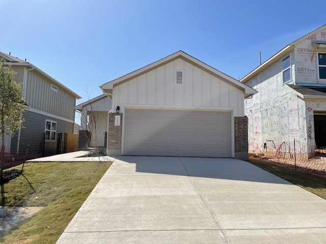 view of front facade with a garage, an outdoor structure, and a front yard