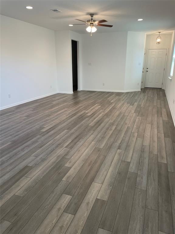 unfurnished room featuring ceiling fan and dark wood-type flooring